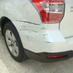 Before and after photographs of a damaged white Subaru that was repaired by Elite Paint & Body Shop in West Palm Beach, Florida